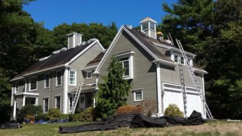 Completed shingle re-roof on a gray colonial home