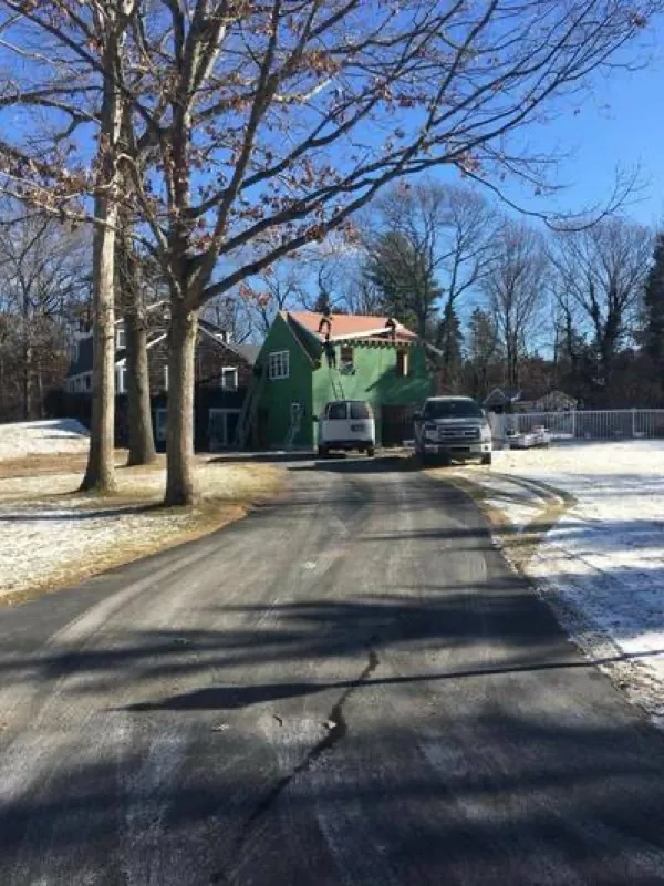 Roofing crew working on a green house in winter