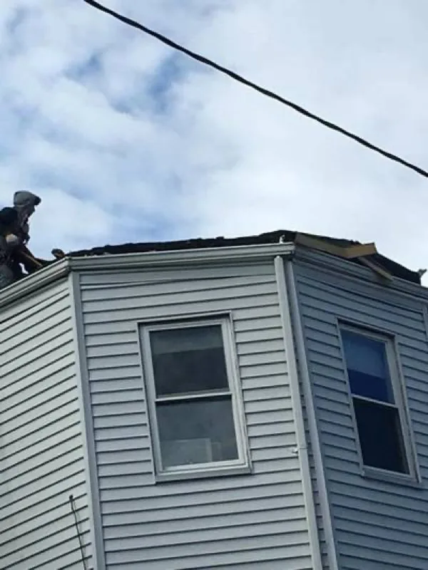 Roofer working along the edge of a roof